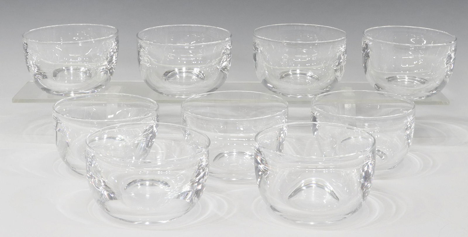 (9) STEUBEN COLORLESS LEADED ART GLASS BOWLS: (lot of 9) Steuben colorless leaded art glass bowls, mid 20th c., engraved signature 'S,' approx 2.5"h, 4"diam; 7.5lbs total **Provenance: A fine Santa Fe, New Mexico estate collection** Start Price: