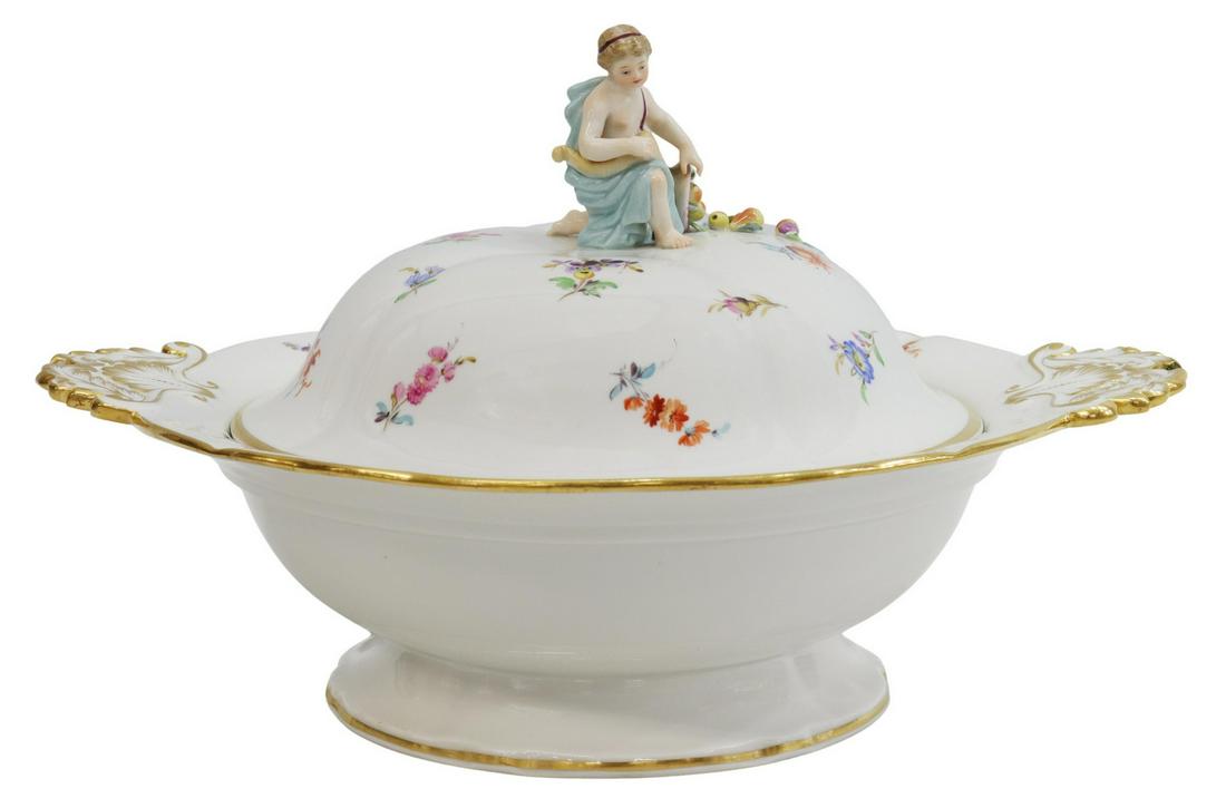 MEISSEN 'SCATTERED FLOWERS' LIDDED VEGETABLE DISH: Meissen porcelain lidded vegetable dish, in the "Scattered Flowers" pattern, figural knop showing draped putto with cornucopia, having dual gilt foliate handles, (one) handle with minor chip, approx 8