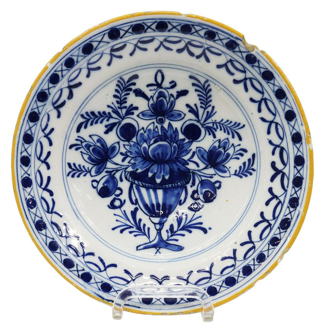 DELFT BLUE & WHITE FAIENCE PLATE, 18TH C.: Delft blue and white faience plate, late 18th c., having running foliate border, center well with vase of flowers, some glaze flakes, rim chips, approx 9"diam, 1.25lbs **Provenance: A fine Santa Fe, N
