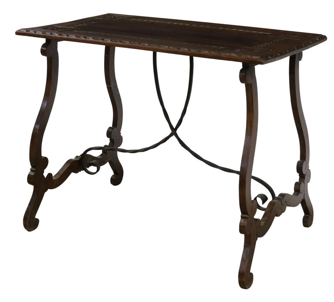 SPANISH BAROQUE STYLE TABLE IRON STRETCHERS: Spanish Baroque style table, 20th c., having patera and geometric carving, rising on ox yoke style legs, joined by iron stretcher, approx 29.75"h, 38"w, 22.5"d **Provenance: A fine Santa Fe, New Mexic
