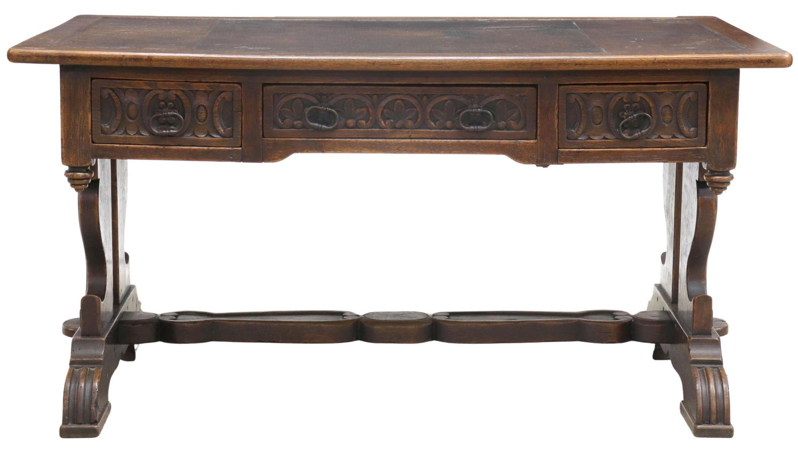 SPANISH RENAISSANCE REVIVAL OAK WRITING DESK: Spanish Renaissance Revival oak writing desk, 19th c., rectangular top inset with embossed leather writing surface, over richly carved apron, three drawers, rising on shaped supports, ending in trestl