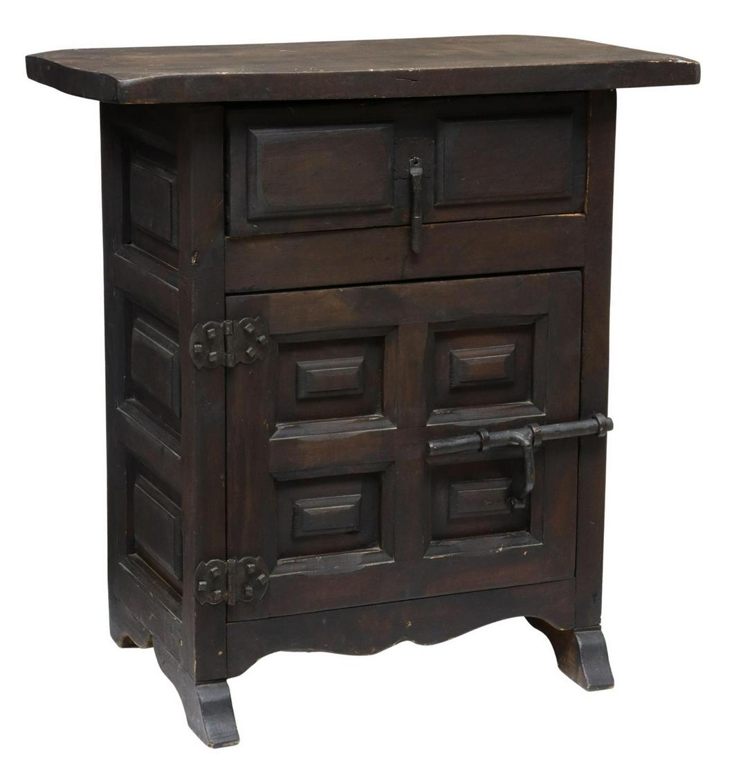 SPANISH BAROQUE STYLE PANELED SIDE CHEST: Spanish Baroque style side chest/ nightstand, early 20th c., overhanging rectangular top, case fitted with a single drawer over cabinet door, iron slide bolt, paneled sides, rising on molded feet, app