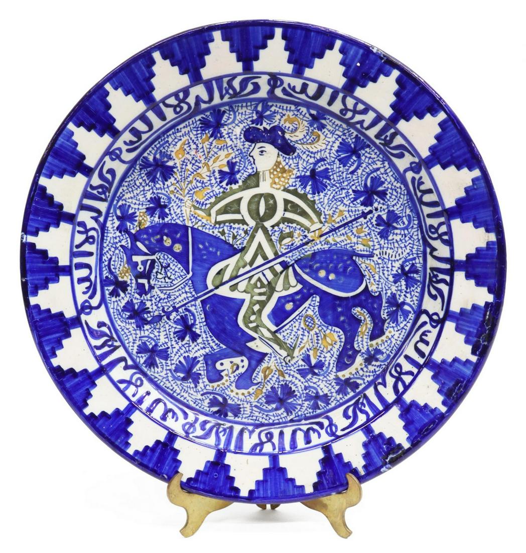 HISPANO-MORESQUE REVIVAL DON QUIXOTE CHARGER: Hispano-Moresque Revival pottery charger, early 20th c., cobalt blue glazed geometric border with stepped design, central well with depiction of Don Quixote on horseback with lance, intact with hairli