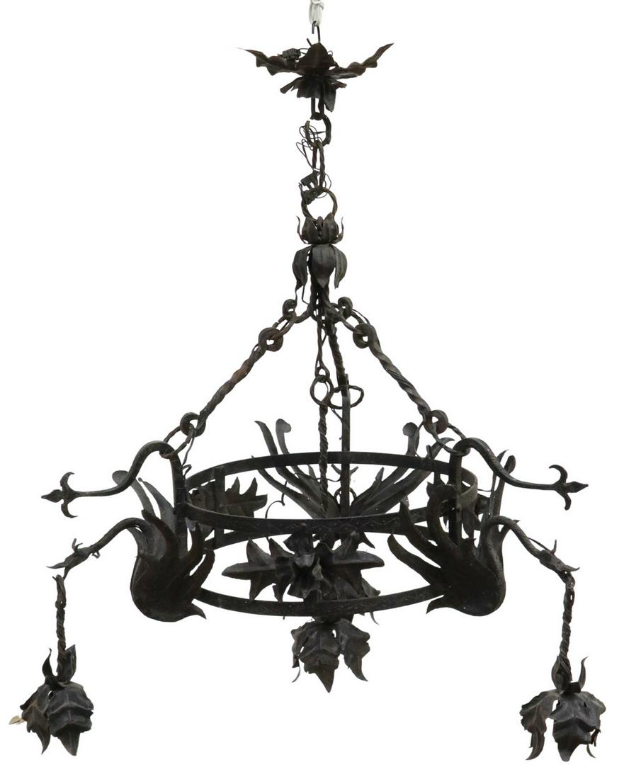 SPANISH GOTHIC REVIVAL IRON FOUR-LIGHT CHANDELIER: Spanish Gothic Revival wrought iron four-light chandelier, early 20th c., chain supporting central ring, three winged dragons with foliated drop lights, additional drop light at center, in need of wir