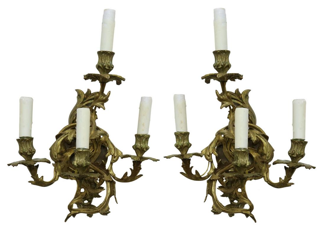 (2) LOUIS XV STYLE GILT BRONZE FOUR-LIGHT SCONCES: (pair) Louis XV style gilt bronze wall sconces, 19th c., converted candelabra, having four foliate scroll arms ending in bobeches, candle cups now mounted with wax coated candle covers, approx 18"h, 1