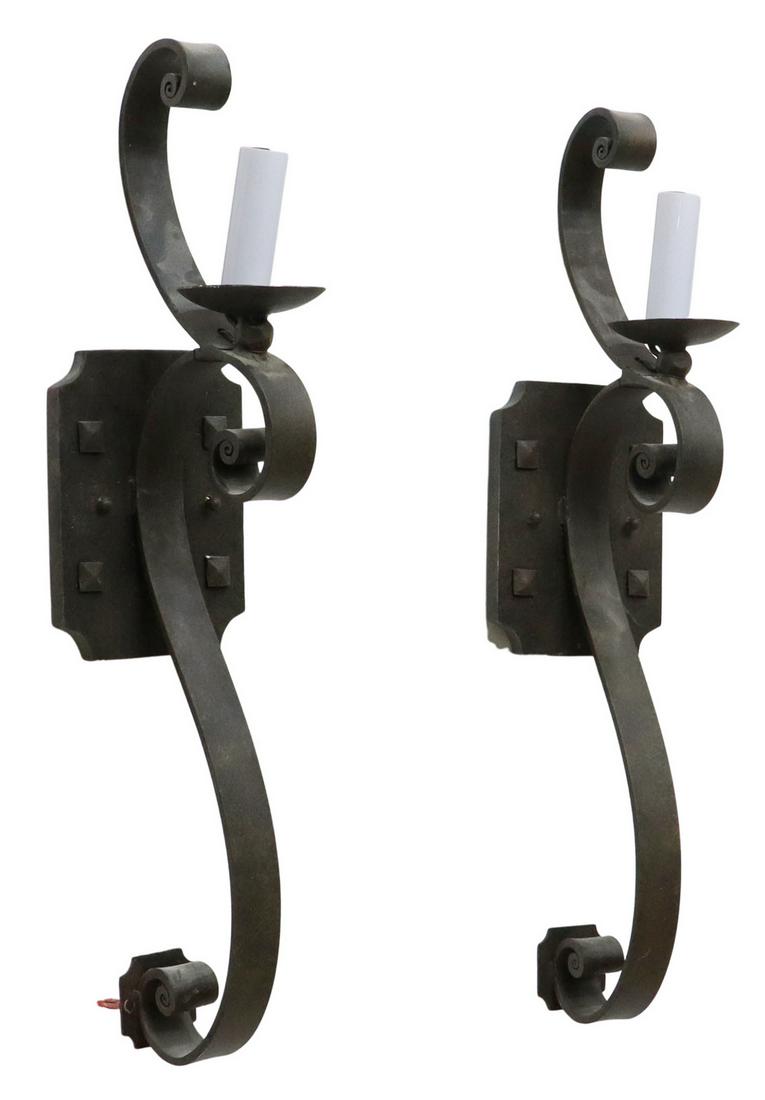 (2) LARGE WROUGHT IRON ONE-LIGHT WALL SCONCES: (pair) Large wrought iron wall sconces, 20th c., having studded wall plate, supporting single scrolled arm, supporting faux candle, approx 27"h, 6"w, 6.5"d; 16.5lbs total **Provenance: A fine Santa Fe