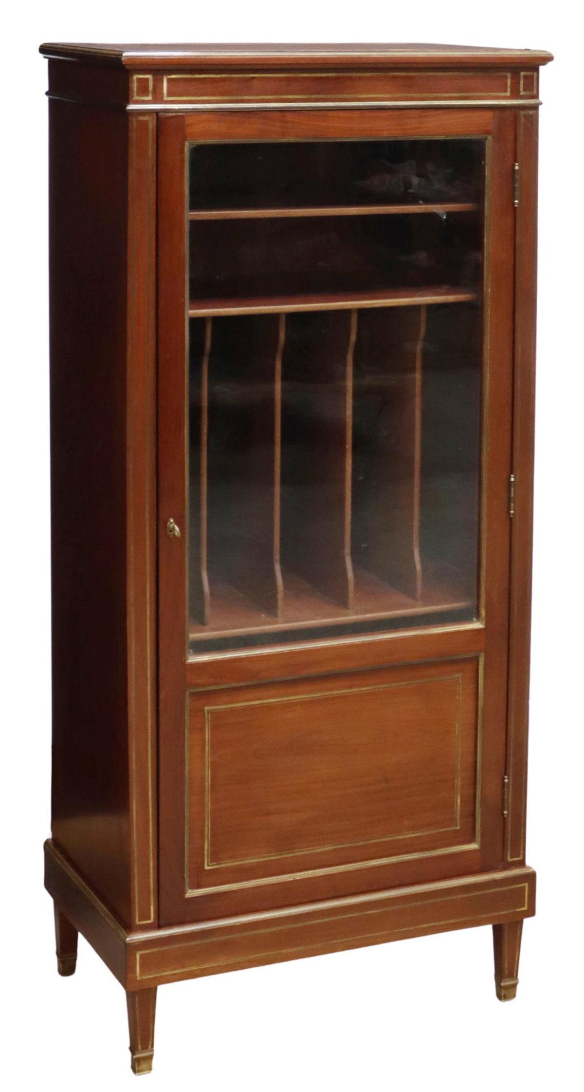 FRENCH LOUIS XVI STYLE MAHOGANY MUSIC CABINET: French Louis XVI style mahogany music cabinet, late 19th c., molded cornice, over case fitted with single glazed door, brass trim, opening to interior shelves, sectioned sheet music storage, rising on