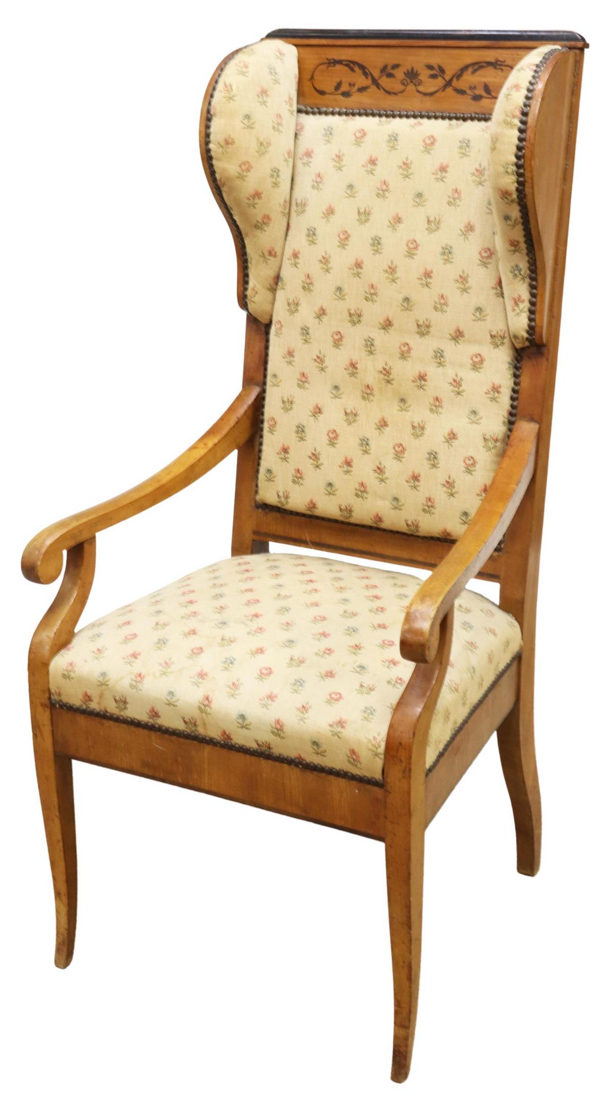 BIEDERMEIER STYLE WINGBACK ARMCHAIR: Biedermeier style wingback armchair, mid 19th c., fruitwood frame with marquetry and parquetry accents, supporting padded upholstered seat and back in floral pattern fixed with nail head trim, shaped 