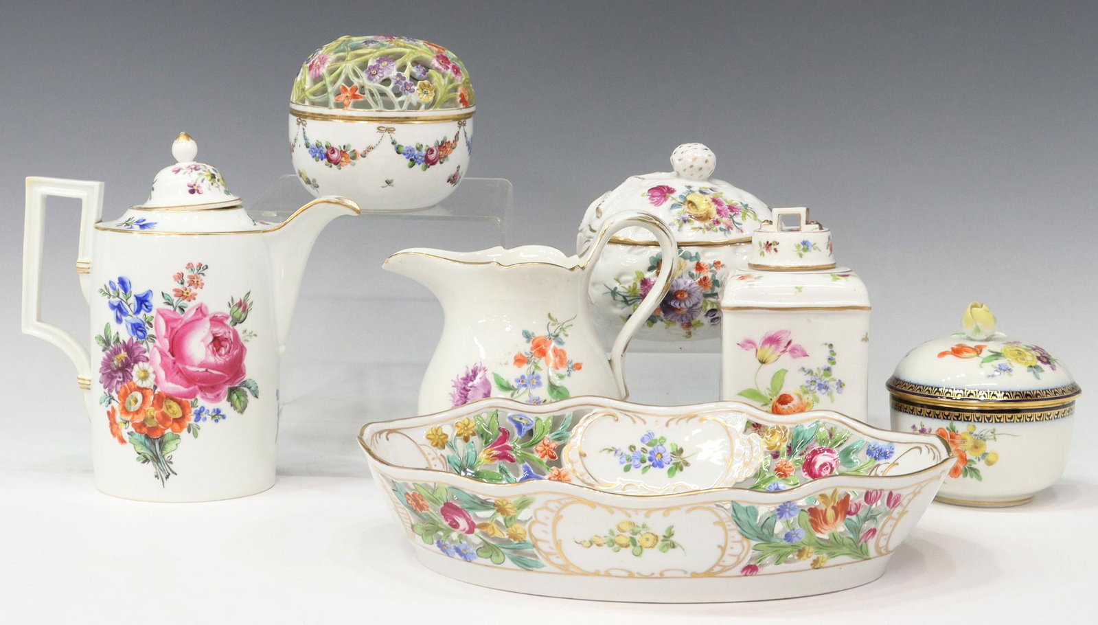 (7) MEISSEN & DRESDEN PORCELAIN FLORAL TABLE ITEMS: (lot of 7) Porcelain table items, all having parcel gilt accents, with hand-painted polychrome floral motifs, including: (3) Meissen porcelain items, comprising: (one) small coffee pot, with interior 
