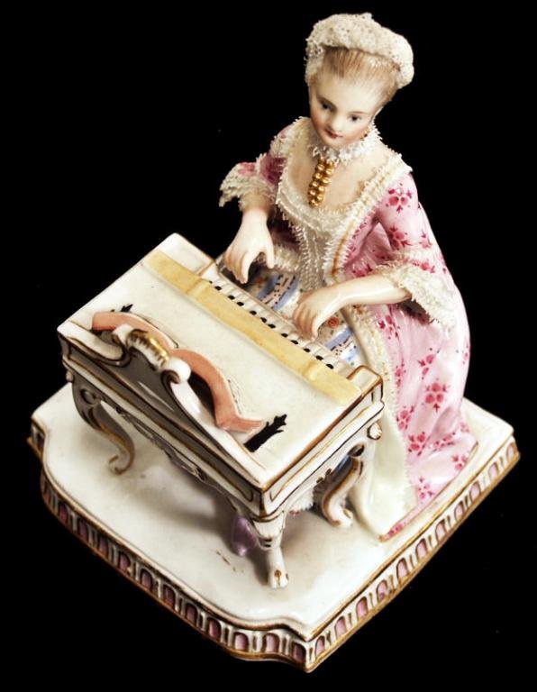 MEISSEN PORCELAIN FIGURE EBLEMATIC OF "HEARING": Meissen porcealin figure, "Hearing", from the five senses series modeled by by J.C.Schoenheit, depicting a seated lady poised to play the harpsichord, her elegant dress painted with flowers and trimme
