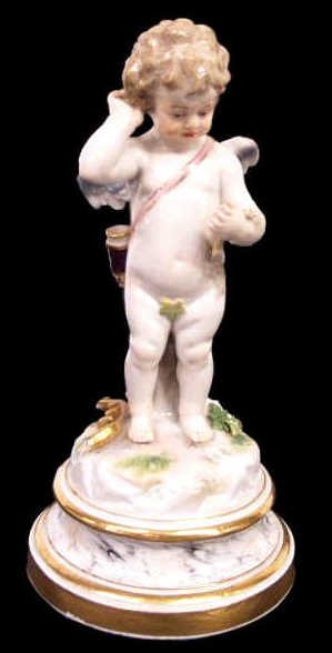 MEISSEN PORCELAIN WINGED CUPID WITH BASKET & BOW: Meissen porcelain figure, late 19th/early 20th c., modeled as a winged cupid with basket, gilt bow and quiver, raised on a marbelized base with gilt borders, blue crossed swords mark underglaze, incis