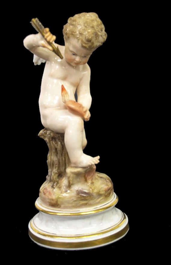MEISSEN PORCELAIN FIGURE, CUPID & PIERCED HEART: Meissen porcelain figure, late 19th/early 20th c., modeled as a winged cupid holding a pierced heart and arrow, raised on a marbelized base with gilt borders, blue crossed swords mark underglaze, inci