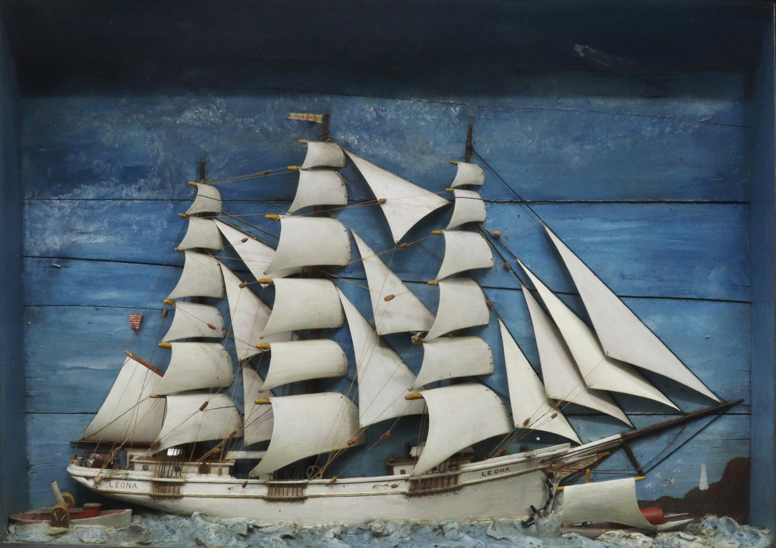LARGE FRAMED NEW ENGLAND SHIP DIORAMA, 19TH C.: American Folk Art framed ship diorama, New England, 19th c., depicting the American three-masted schooner Leona, displayed in glazed giltwood frame, against painted paneled back, two small boats foreg