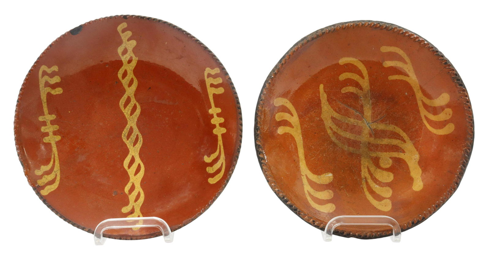 (2) AMERICAN SLIP-DECORATED REDWARE POTTERY PLATES: (lot of 2) American slip-decorated redware pottery plates, 19th c., having a coggled rim, encircling linear yellow slip cup designs, unglazed bottom, rim chips, glaze crazing and wear, (one) with inta