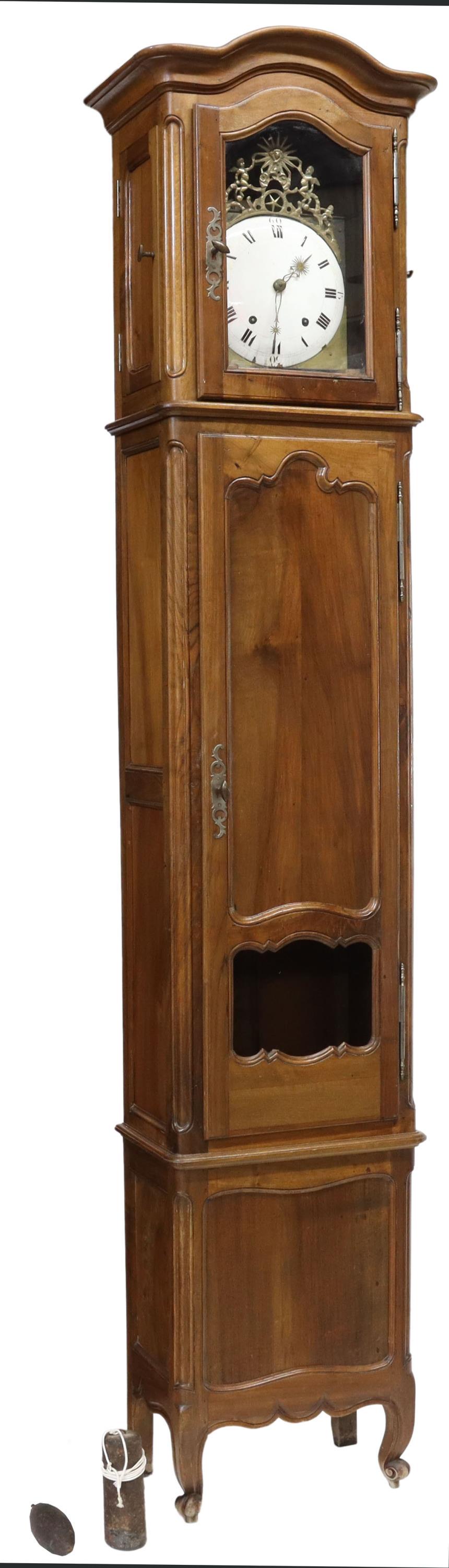 FRENCH MORBIER WALNUT LONG CASE CLOCK: French morbier walnut long case clock, mid 19th c., having a molded top, over walnut case, single door with pendulum viewing panel, on cabriole legs, ending in whorl feet, housing gilt metal frame wit
