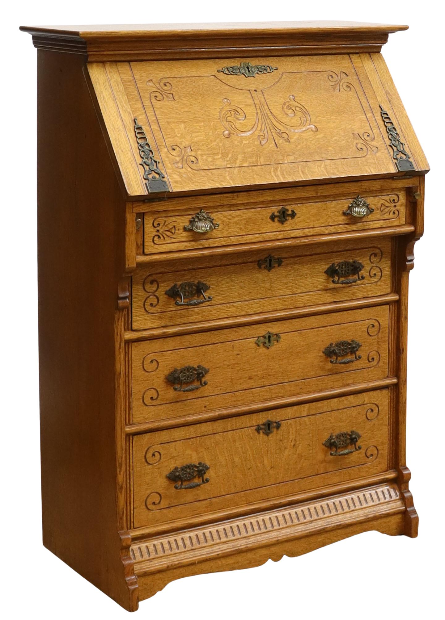 AMERICAN EASTLAKE OAK SLANT-FRONT DESK, C.1900: American Late Victorian oak slant-front desk, c.1900, having molded cornice, over slant-front desk, opening to writing surface and fitted gallery, over four exterior drawers, with carved foliate motif
