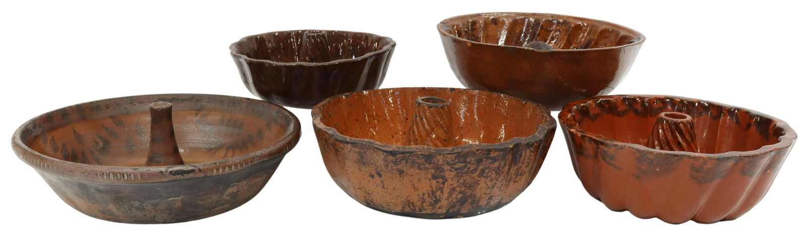 (5) AMERICAN REDWARE POTTERY MOLDS, 19TH C.: (lot of 5) American redware pottery molds, 19th c., similarly styled, various sizes, some with sponged manganese surface decoration, largest: approx 10.5"diam; 12lbs total **Provenance: O'Neill-Leonar