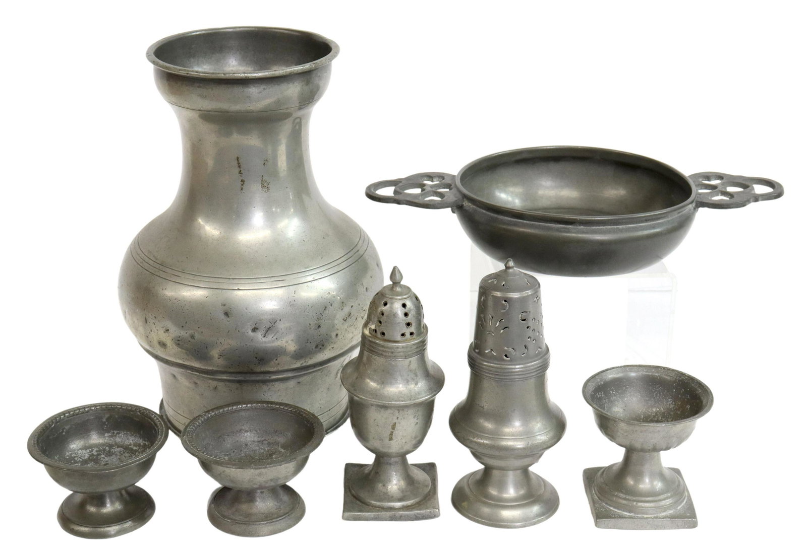 (7) AMERICAN PEWTER TABLEWARE, 18TH-20TH C.: (lot of 7) American pewter tableware, 18th-20th c., various styles and makers, comprising: (1) Boardman carafe, initialed T.D. and bearing circle eagle mark; (3) footed salt cellars, having pressed pa