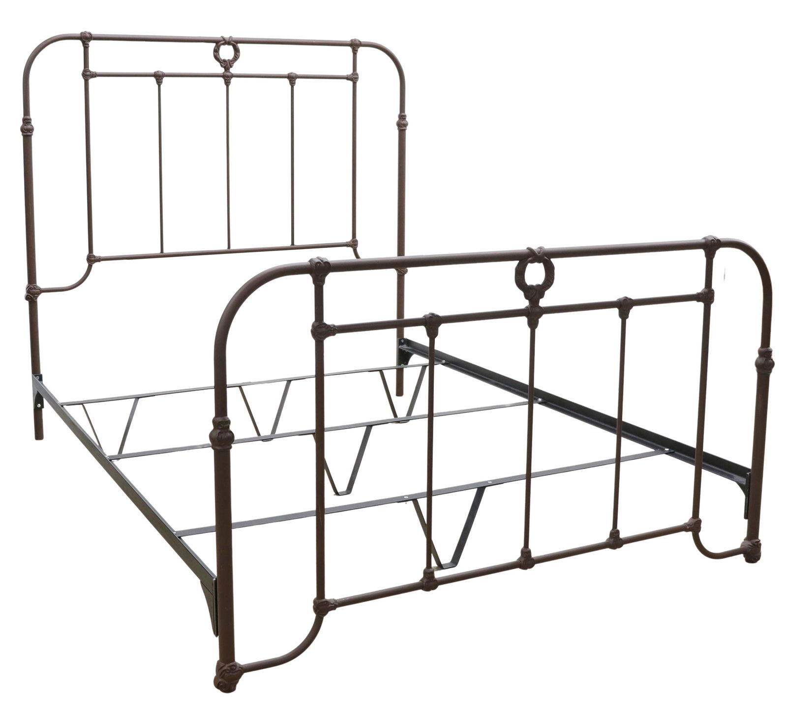 CAST IRON QUEEN-SIZE BED: Cast iron queen-size bed, slatted headboard and footboard, with wreath crest, exterior: approx 57"h, 85"l, 60.5"w, interior: approx 81.5"l, 60"w Start Price: $80.00
