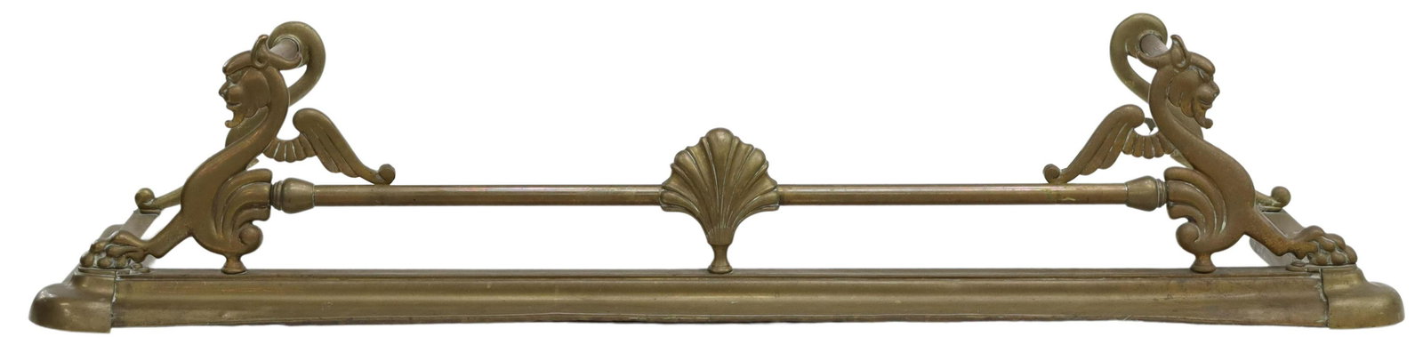 BRASS FIREPLACE FENDER WINGED GRIFFINS: Brass fireplace fender, late 19th/ early 20th c., with stylized winged griffins, approx 12"h, 54"l, 15"d Start Price: $80.00