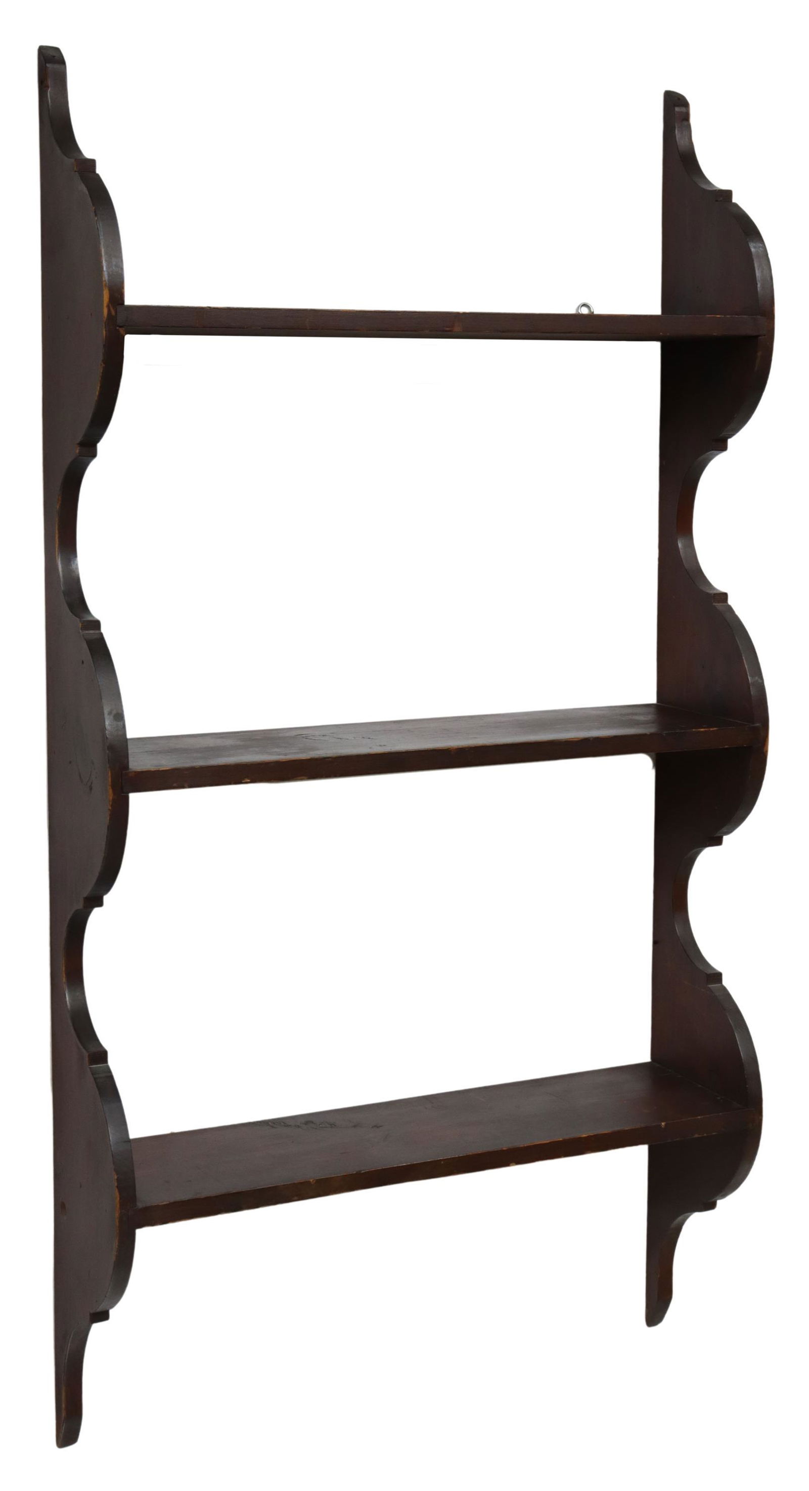 AMERICAN PRIMITIVE PAINTED PINE HANGING WALL SHELF: American Primitive painted pine hanging wall shelf, 20th c., in a red painted finish, having scalloped sides, fitted with three open shelves, approx 46.5"h, 24"w, 6.25"d **Provenance: O'Neill-Leonard