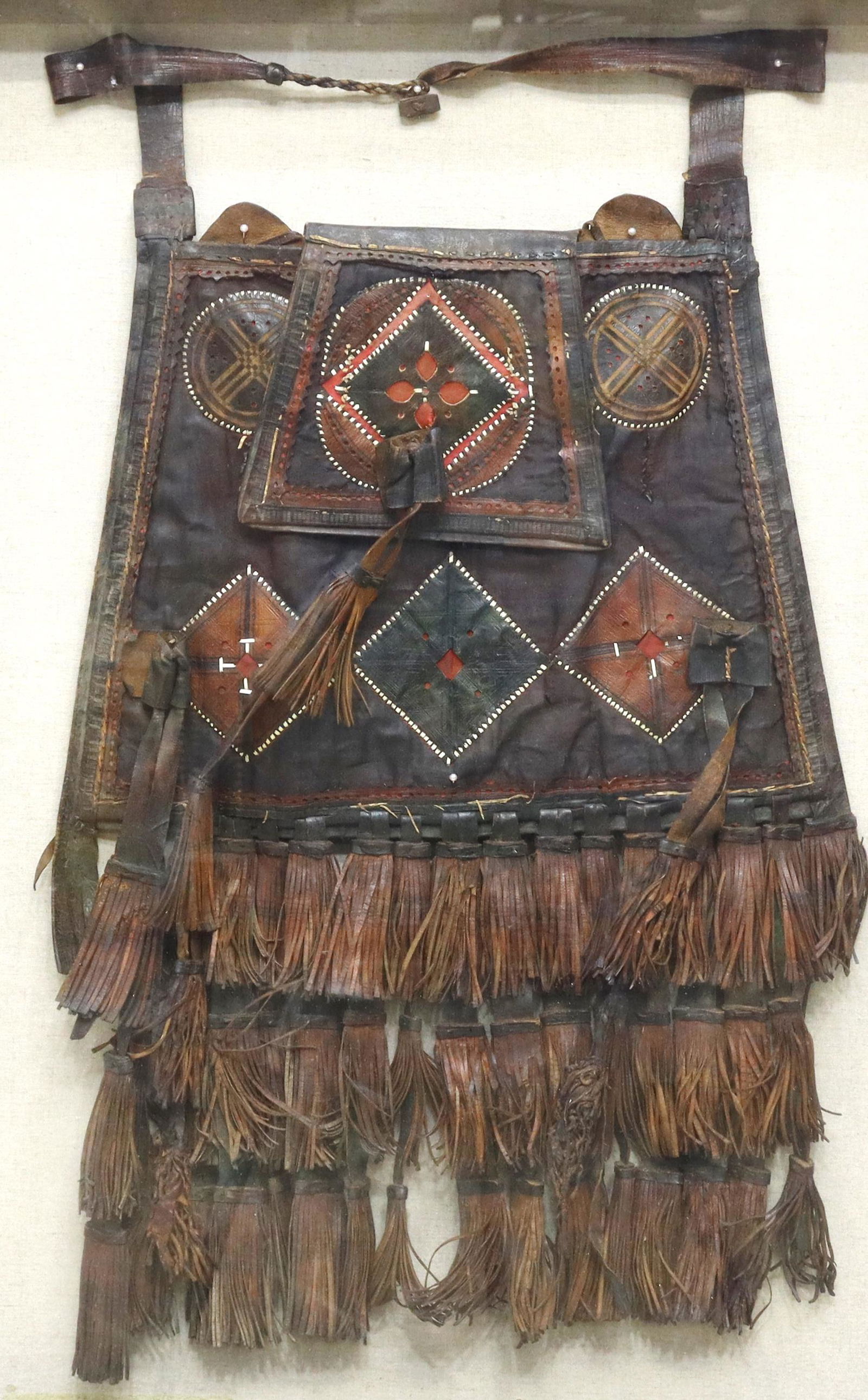 FRAMED TRIBAL MALI WEST AFRICA LEATHER FRINGE BAG: Leather saddle bag with fringe, likely Tuareg or Mande peoples, Mali, West Africa, housed in shadowbox frame, mounted to linen backboard, sight: 28.75"h, 22.75"w, overall: 30.75"h, 24.75"w, 12.5lbs St