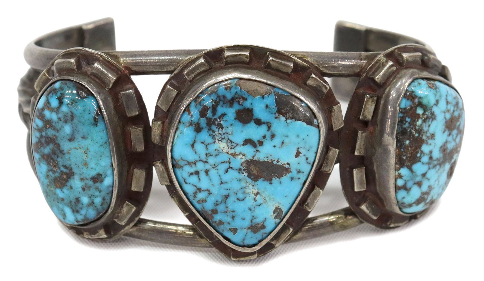 NATIVE AMERICAN SILVER & TURQUOISE CUFF BRACELET: Native American silver (content unknown) cuff bracelet, with three bezel-set turquoise stones, on a split-shank cuff with central twisted wire, approx 1.25"w (at center), interior: approx 5 1/8"w, gap