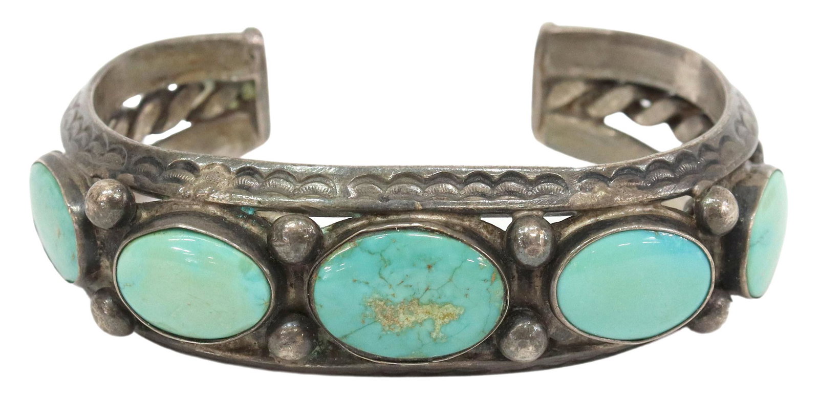 NATIVE AMERICAN SILVER & TURQUOISE CUFF BRACELET: Native American silver (content unknown) cuff bracelet, with five oval, bezel-set turquoise stones, beaded accents, on a stamped split-shank cuff with central twisted wire, approx 1.25"w (at center), 