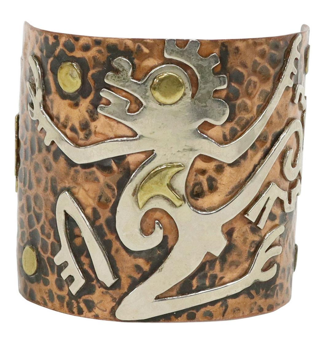 MEXICO MODERNIST MIXED METAL CUFF BRACELET: Modernist mixed metal cuff bracelet, Mexico, in the manner of Casa Maya, hammered copper ground applied with silver and brass Monkey God and accents, approx 2 3/8"w, interior: approx 5.75", gap: appro