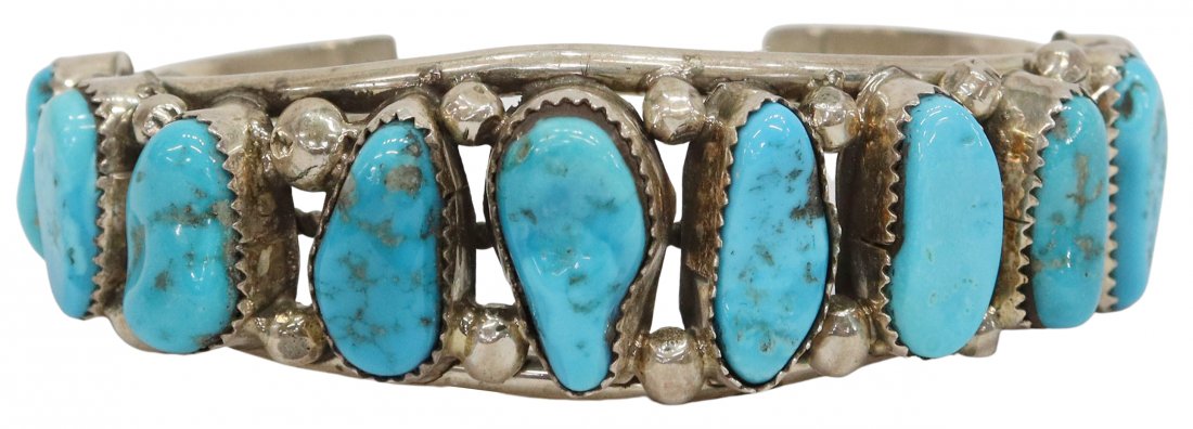 NATIVE AMERICAN STERLING & TURQUOISE CUFF BRACELET: Native American sterling silver and turquoise cuff bracelet, ten bezel-set turquoise stones spaced by beads, set on an openwork split cuff with central twisted wire, stamped sterling to one end, appro