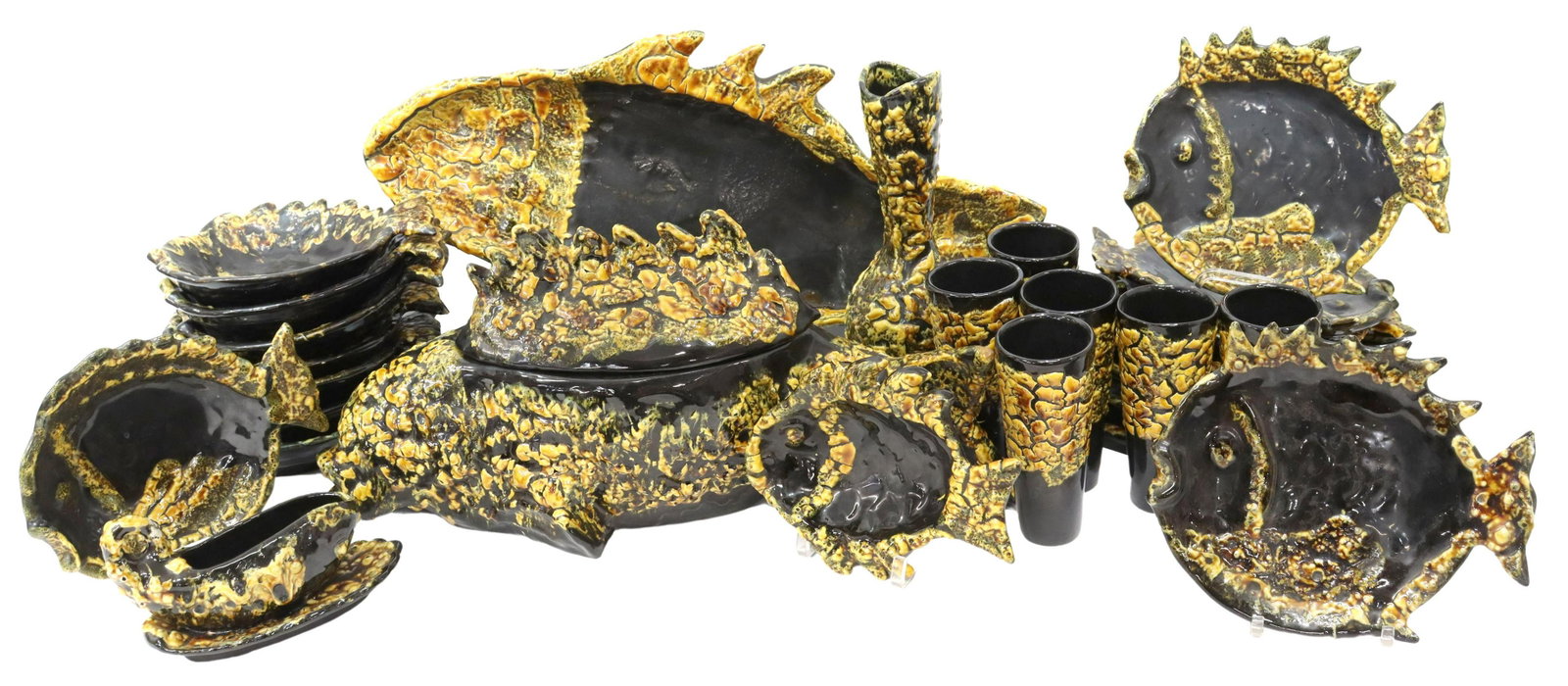 (27) MID-CENTURY LUC VALLAURIS LAVA GLAZE FISH SET: (lot of 27) French mid-century modern fish service, Luc Vallauris (Auguste Lucchesi, French, b.1913), c.1960s, in fat lava glaze, including: (8) plates, 10.5"w, (8) bowls, 9.75"w, (6) tumblers, 7"h, (
