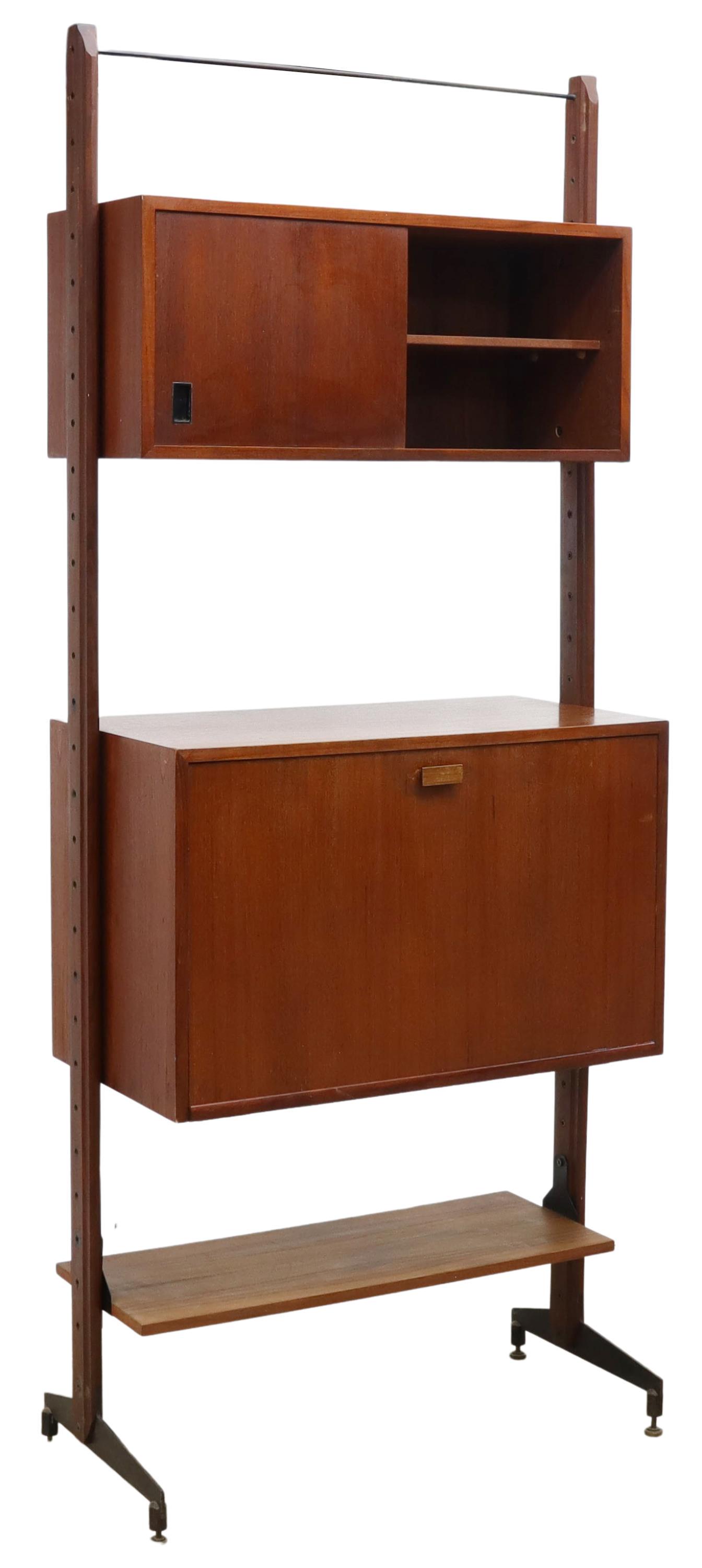 ITALIAN MID-CENTURY MODERN WALL UNIT BOOKCASE: Italian mid-century modern teak wall unit bookcase, c.1960s, rising on two narrow wood adjustable uprights, fitted with two cabinets, (one) having single sliding door opening to two shelves, (one) fal