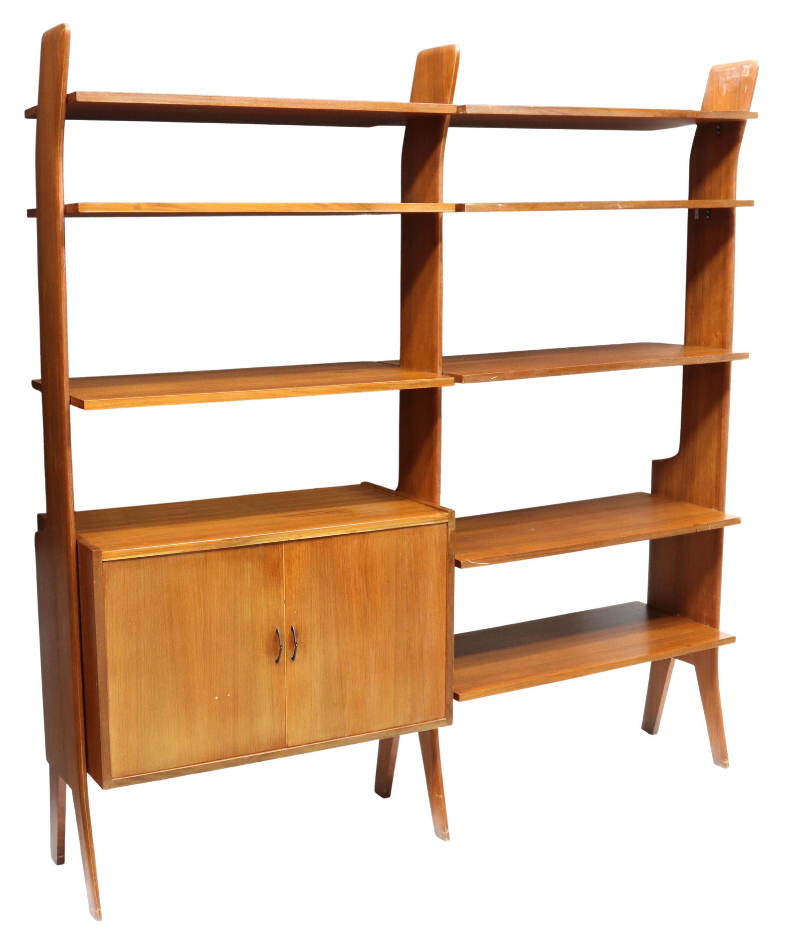 ITALIAN MID-CENTURY MODERN TEAK WALL UNIT BOOKCASE: Italian mid-century modern teak two-unit bookcase, c.1960s, eight open display shelves, double-door cabinet opening to interior shelf, on angled supports, approx 68.5"h, 65"w, 16"d Start Price: $400.0