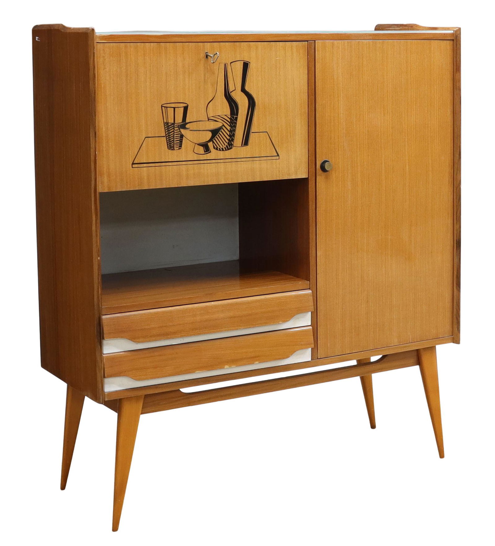 ITALIAN MID-CENTURY MODERN BAR CABINET: Italian mid-century modern bar cabinet, c.1960s, glass top, case fitted with two cabinet doors, two drawers, drop-front cabinet with bar graphic at front, opening to interior shelf, flanked by long si