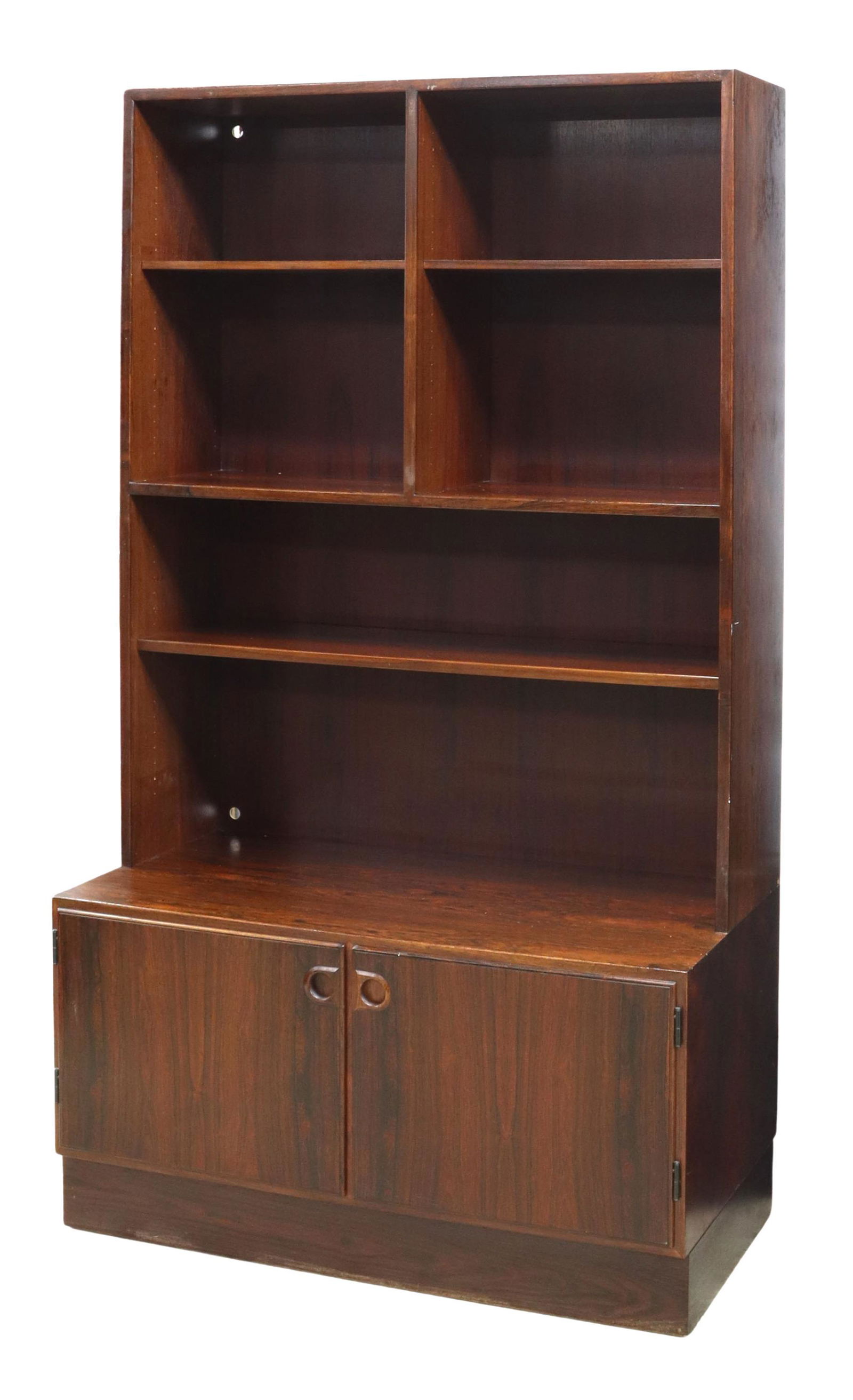DANISH MID-CENTURY MODERN ROSEWOOD BOOKCASE: Danish mid-century modern rosewood bookcase, c.1960s, having five adjustable shelves, two cabinet doors opening to shelving, rising on closed base, drilled cord holes in back panel, approx 69"h, 39.25