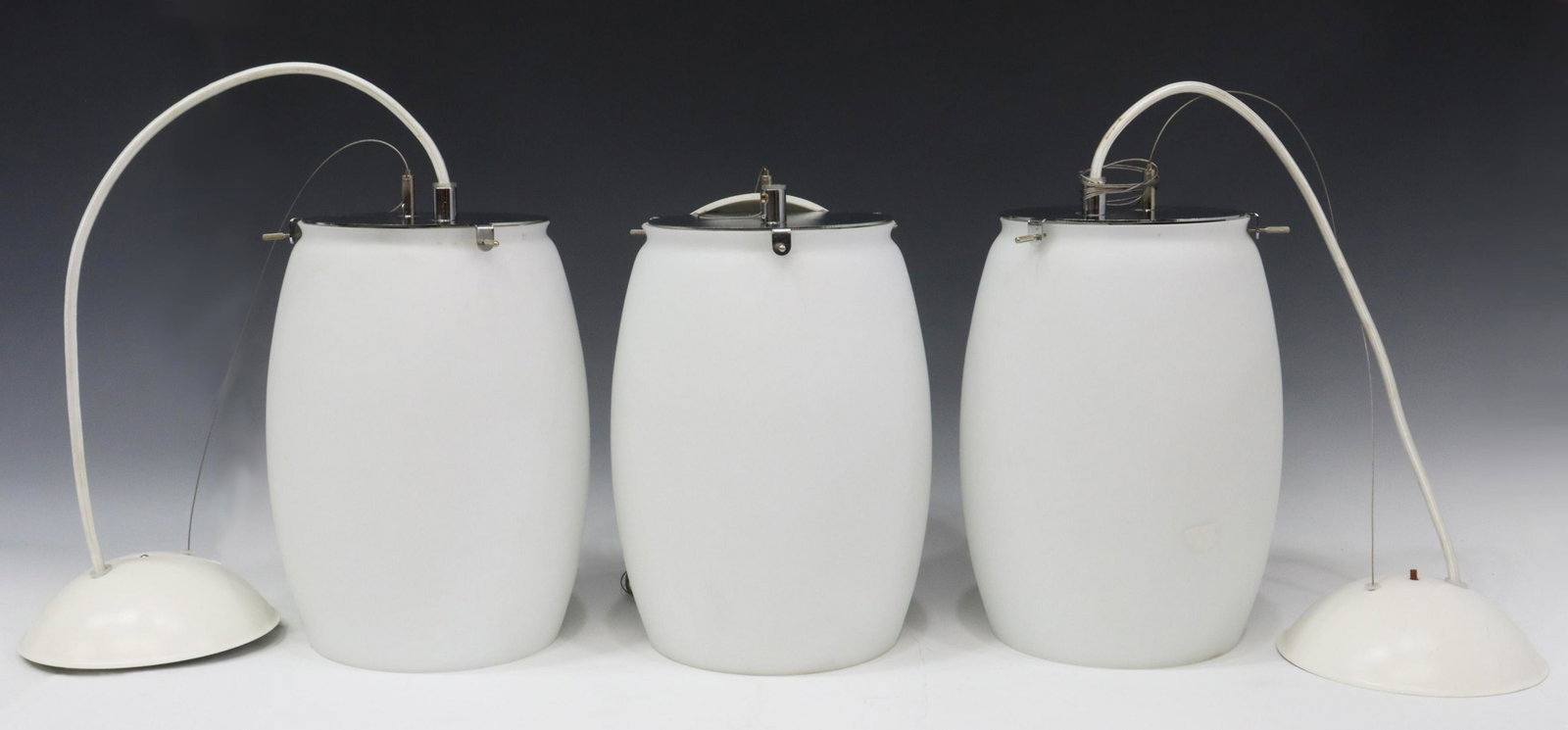 (3) ZERO LIGHTING CONTEMPORARY PENDANT LIGHTS: (lot of 3) Contemporary pendant lights, Zero Lighting, Sweden, late 20th c., having chrome caps over frosted cylindrical globes, white metal ceiling mounts, retaining maker's tags, in need of wiring, 