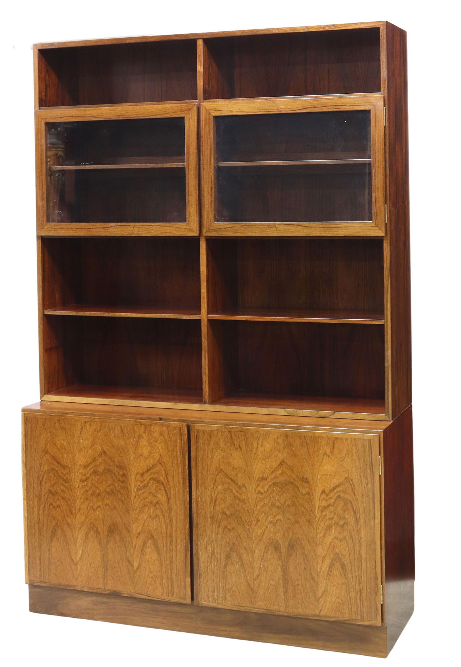 DANISH OMANN JUN MID-CENTURY ROSEWOOD BOOKCASE: Danish mid-century modern rosewood bookcase, manufactured by Omann Jun, c.1960s, upper stepback section with open display shelves, two glazed cabinet doors, lower case fitted with double-door cabinet