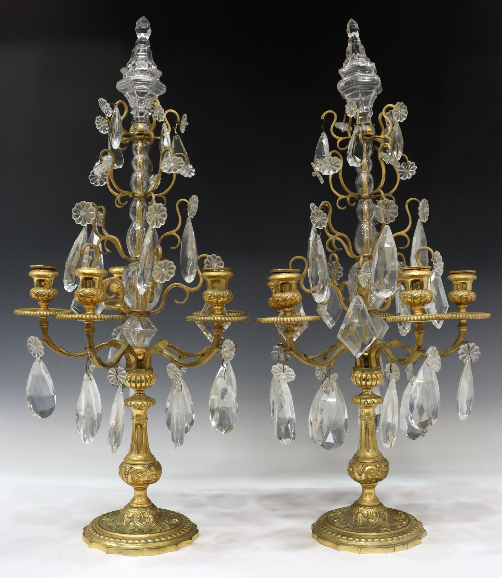 (2) FRENCH BRONZE & CRYSTAL GIRANDOLE CANDLEABRA: (pair) French bronze dore and crystal five-light girandole candelabra, early 20th c., having colorless pressed glass standard topped with large finial supporting five tiers of prisms, volute arms endi