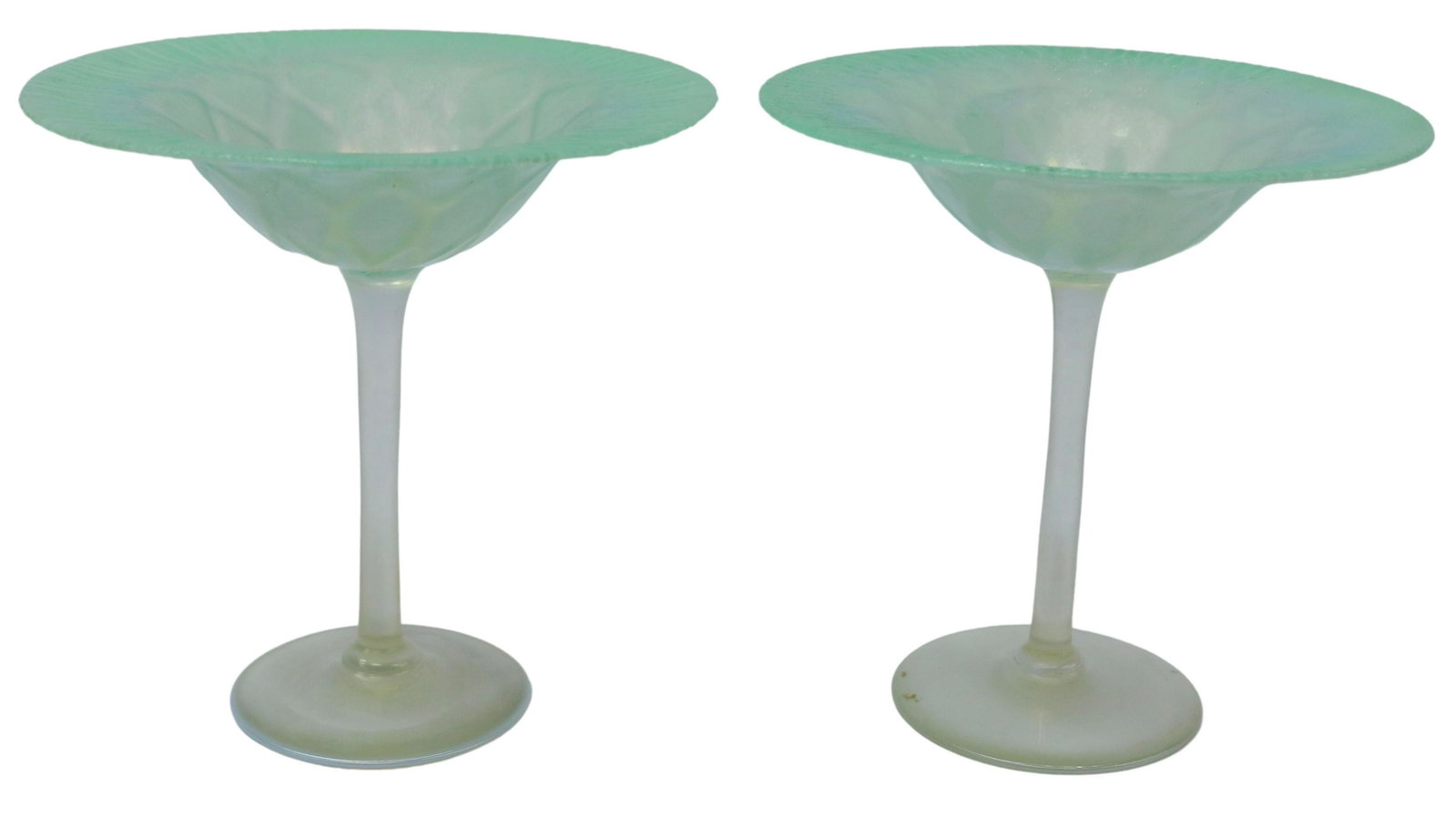 (2) L.C. TIFFANY GREEN FAVRILE ART GLASS COMPOTES: (pair) American favrile art glass compotes, Louis Comfort Tiffany (New York, 1848-1933), early 20th c., pale green glass with stretched rim, white opalescent diamond design, cylindrical stem, on a cir