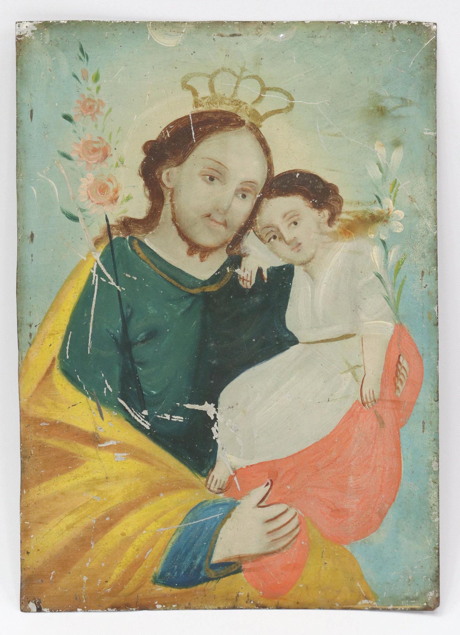 OIL ON TIN RETABLO, SAINT JOSEPH & CHRIST, MEXICO: Unframed oil on tin retablo, Mexico, San Jose (Saint Joseph), depicted wearing a golden crown, in a green robe with yellow mantle, staff of hollyhocks, holding the Christ Child with white lilies, over