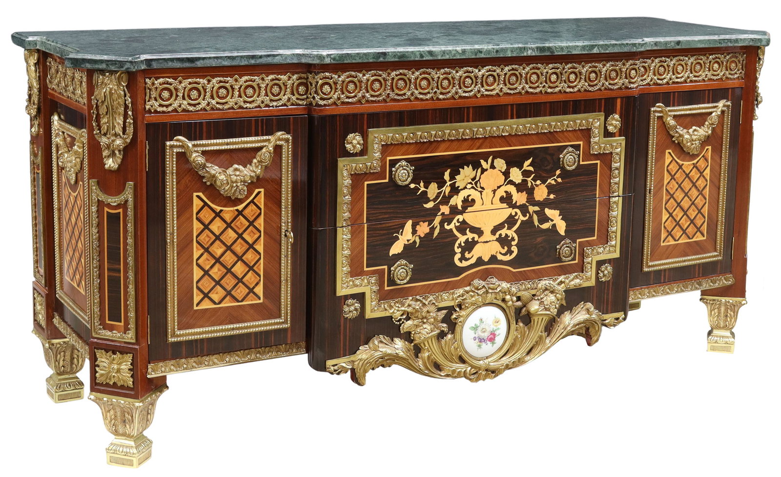FINE FRENCH MARBLE-TOP ORMOLU-MOUNTED COMMODE: French mahogany and rosewood commode, 20th c., shaped green marble top, frieze with gilt bronze rinceau mounts, two centered drawers with floral marquetry, painted porcelain plaque, flanked by side ca