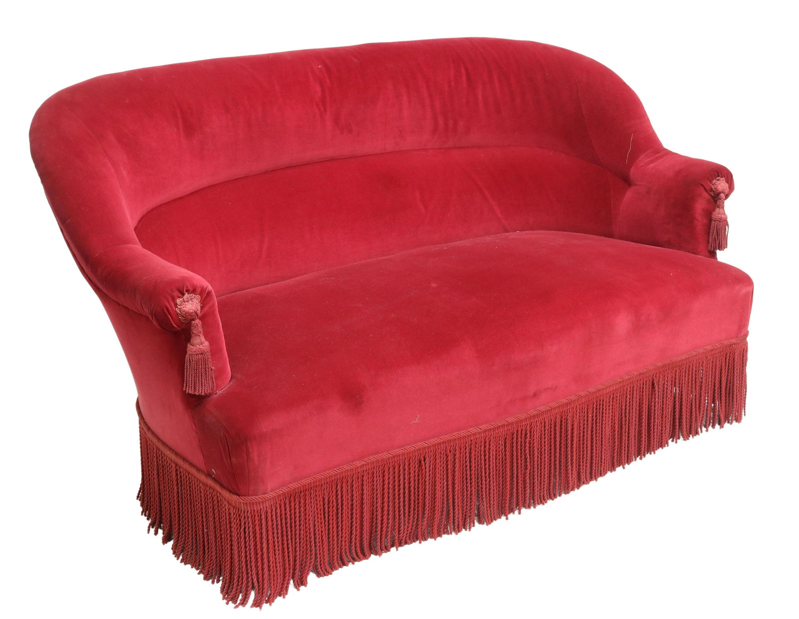 FRENCH NAPOLEON III PERIOD RED VELVET TASSEL SOFA: French Napoleon III period sofa, 19th c., upholstered in red velvet, having padded rounded back, accented with arm tassels, rope fringe skirt, rising on turned wood feet, approx 31"h, 56.5"w, 35"d **N
