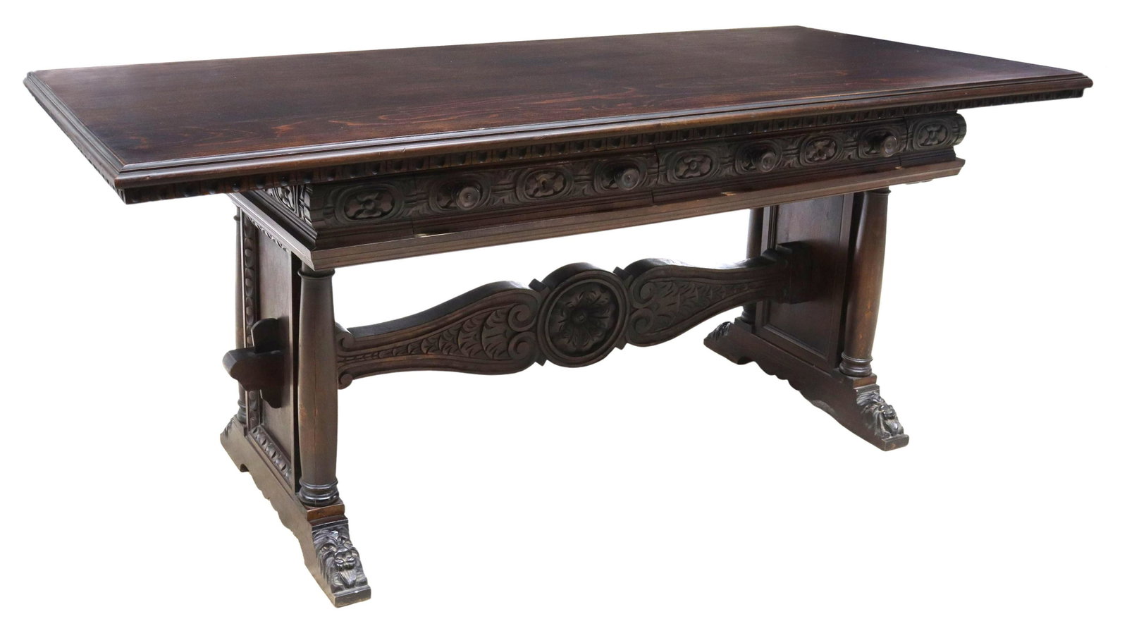 RENAISSANCE REVIVAL LIBRARY TABLE WRITING DESK: Italian Renaissance Revival library table/ writing desk, early 20th c., rectangular top with molded edge, ornamental frieze finished on all sides, two drawers, trestle base with turned columns, carved