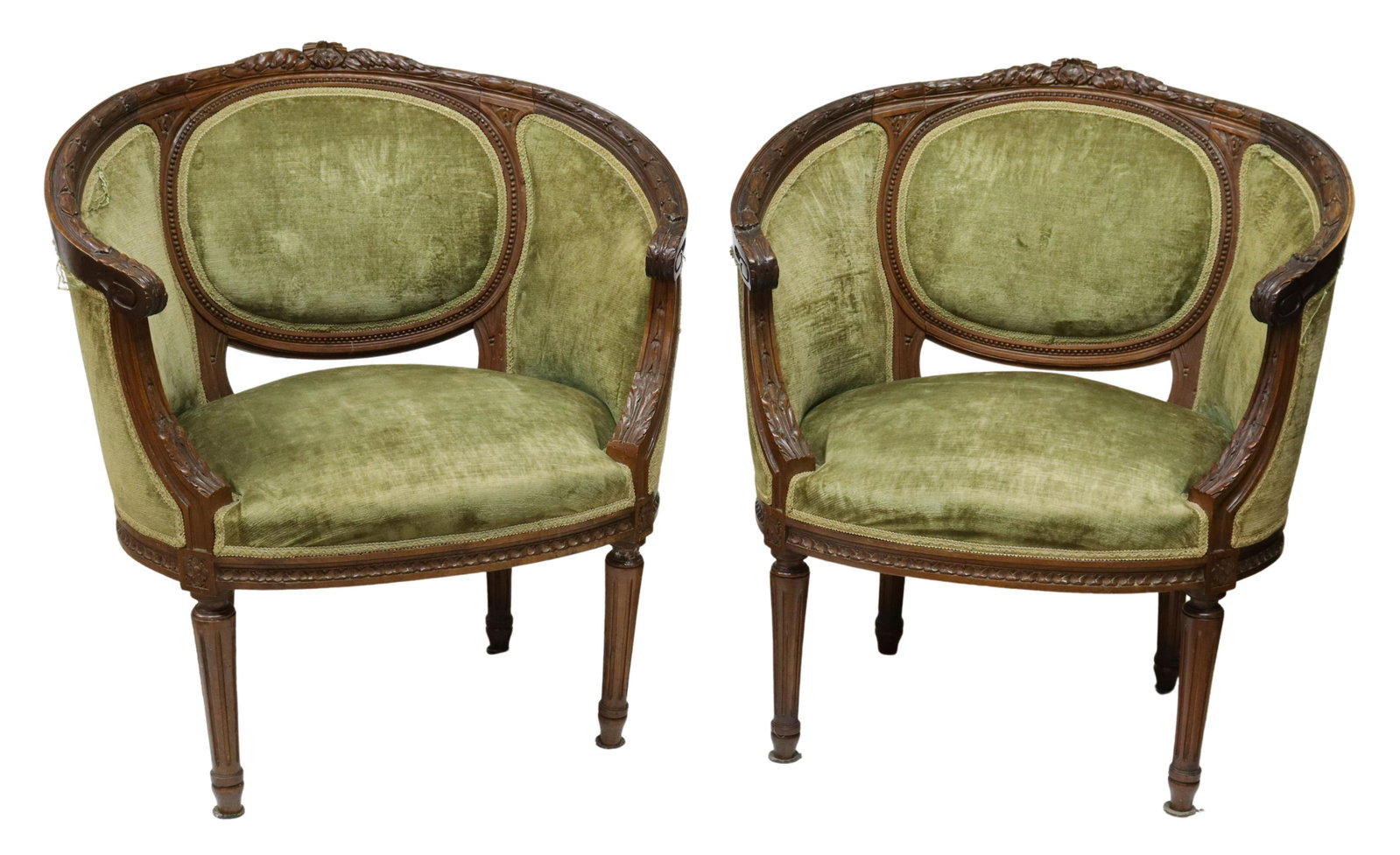 (2) FRENCH LOUIS XVI STYLE FINELY CARVED BERGERES: (pair) French Louis XVI style armchairs, early 20th c., walnut frame carved with ribbon crest and running floral ornamentation, continuous arms having acanthus handholds and supports, enclosing padded