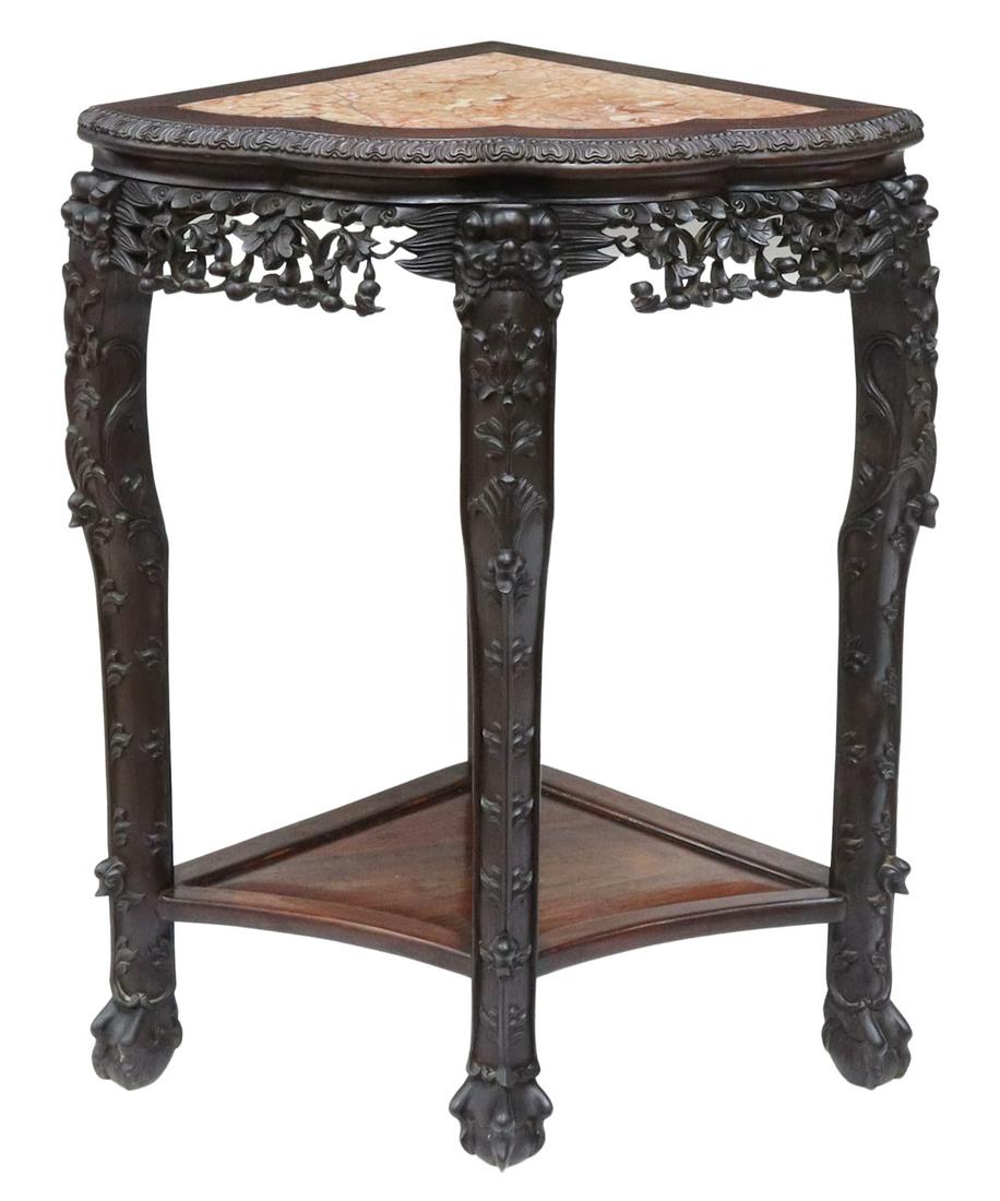 CHINESE MARBLE-TOP CARVED ROSEWOOD CORNER TABLE: Chinese carved rosewood corner table, having shaped inset marble top, over pierced work apron, rising on cabriole legs ornamented with figural mask and foliate motif, joined by medial shelf, ending in