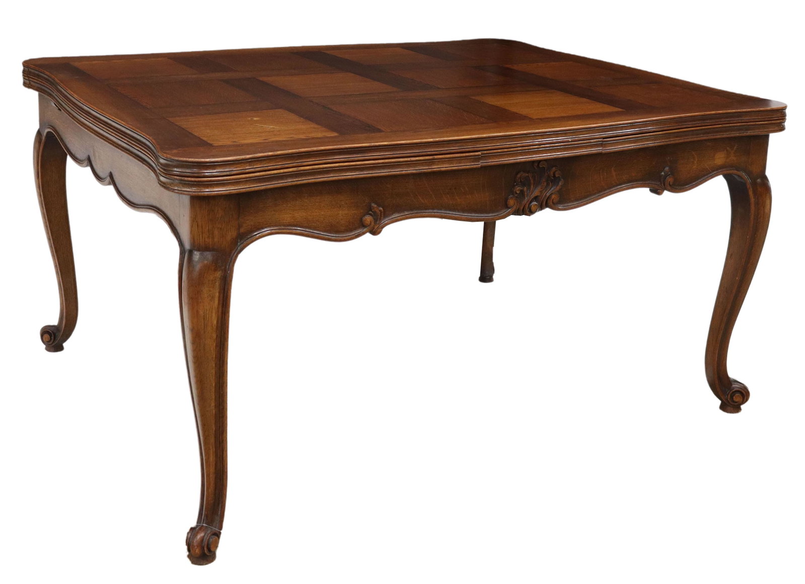 FRENCH LOUIS XV STYLE OAK DRAW-LEAF DINING TABLE: French Provincial Louis XV style oak draw-leaf table, 20th c., parquetry tabletop with finished draw leaves, scalloped apron, rising on cabriole legs, ending in whorl feet, small loss to edge of one l