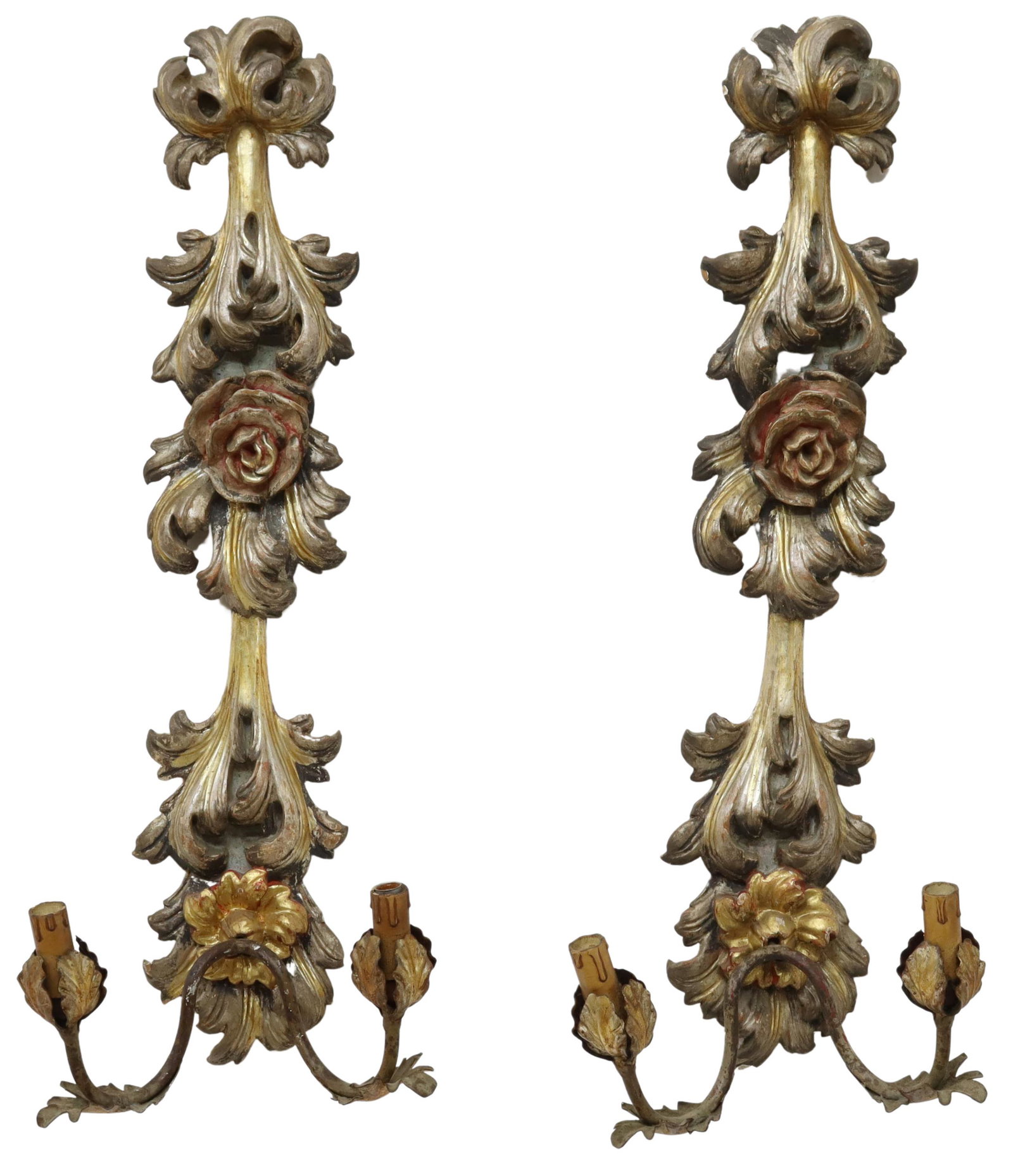 (2) ITALIAN SILVER GILT WOOD TWO-LIGHT SCONCES: (pair) Italian two-light wood sconces, early 20th c., parcel gilt and polychrome painted wall mounts, having relief carved foliate and rose motif, supporting two patinated metal arms ending in petal b