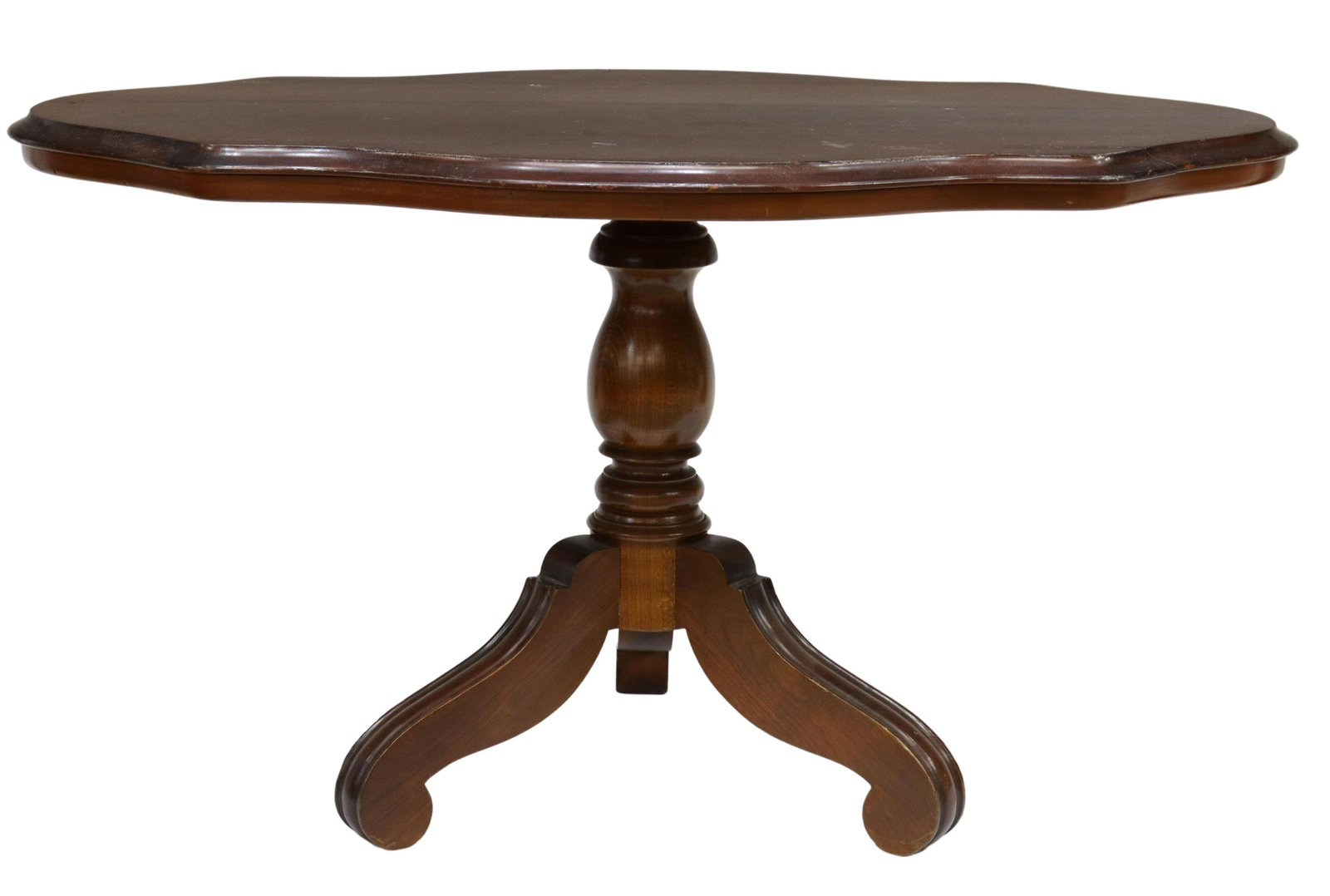 ITALIAN MAHOGANY CENTER PEDESTAL TABLE: Italian low pedestal table, in a mahogany finish, 20th c., shaped top with molded edge, turned center pedestal, rising on three scrolled legs, approx 23"h, 40.25"w, 24.75"d Start Price: $50.00