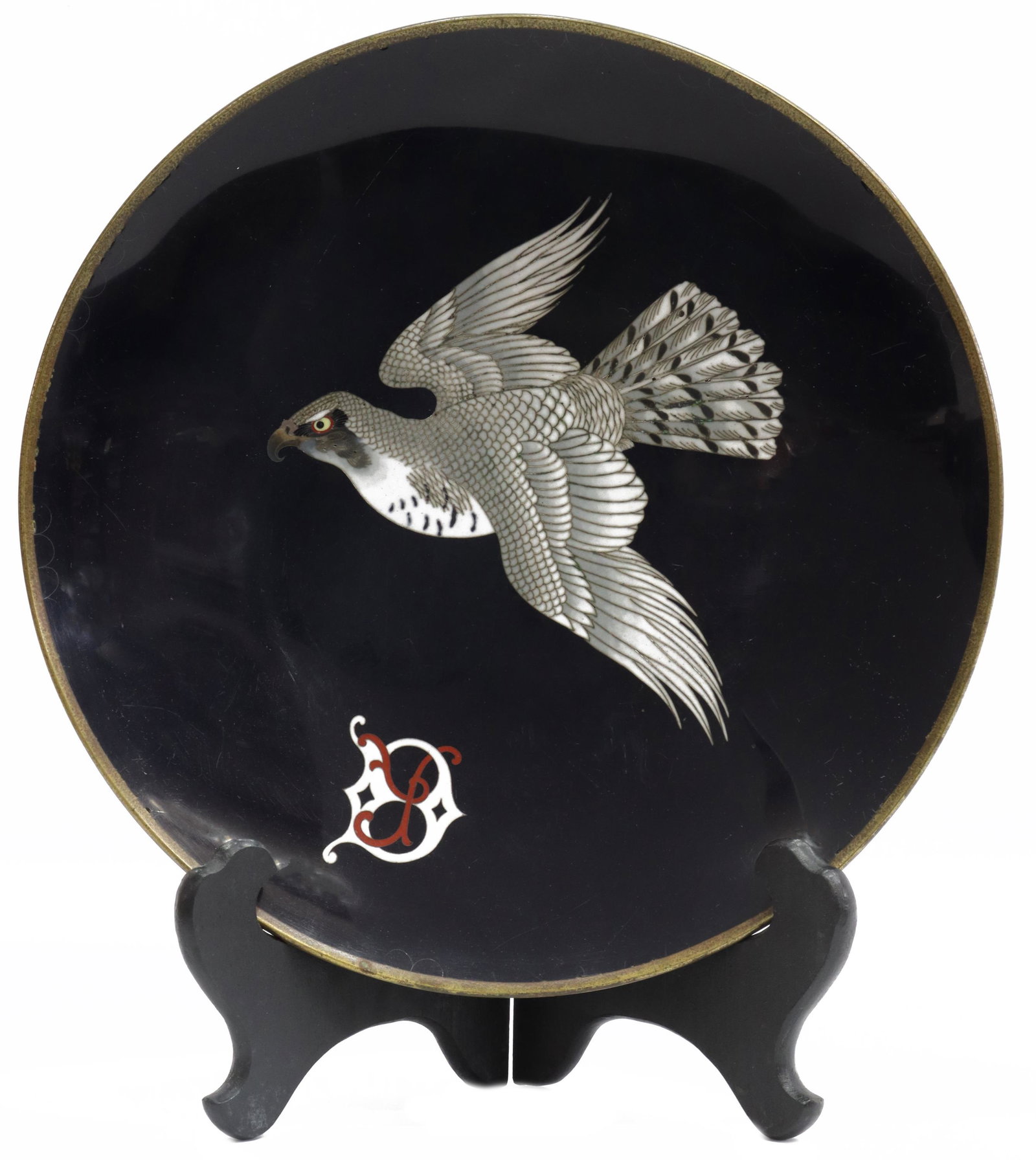 FINE JAPANESE MEIJI CLOISONNE ENAMEL HAWK PLATE: Japanese cloisonne enamel plate, Meiji period (1868-1912), with hawk in flight against a black ground further decorated with entwined initials, reverse with fish scale pattern, some pitting, corrosion