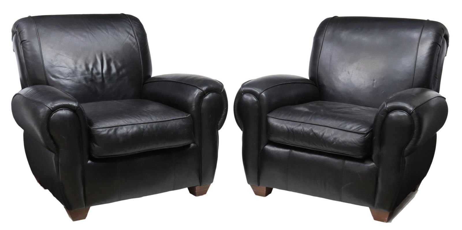 (2) BAUHAUS U.S.A. INC. BLACK LEATHER ARMCHAIRS: (pair) Black leather upholstered armchairs, Bauhaus U.S.A. Inc., late 20th c., with curved back and armrests, removable seat cushion, rising on tapered wood feet, approx 37"h, 39"w, 34"d, seat height:
